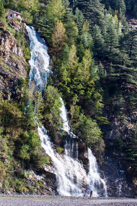 A waterfall meeting river Bhagirathi in Uttarkashi district, Uttarakhand